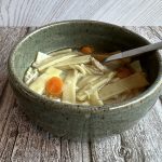 A bowl of chicken noodle soup.
